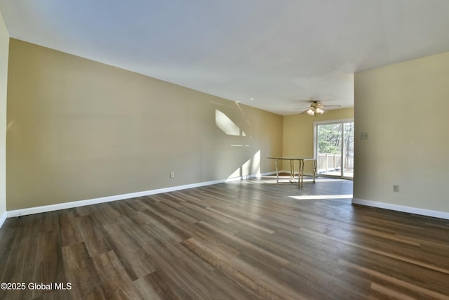 empty room with dark wood-type flooring and ceiling fan