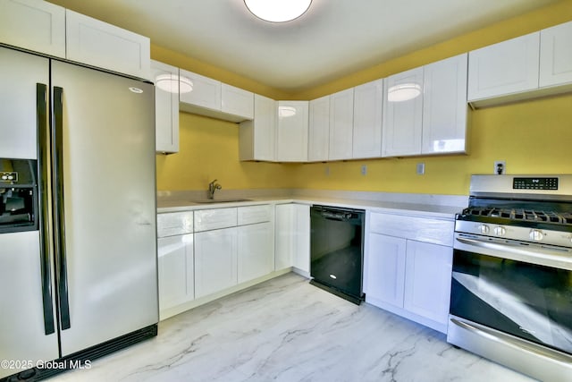 kitchen featuring appliances with stainless steel finishes, sink, and white cabinetry