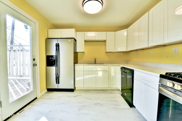 kitchen featuring stainless steel appliances, white cabinets, and sink