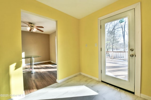 doorway featuring ceiling fan