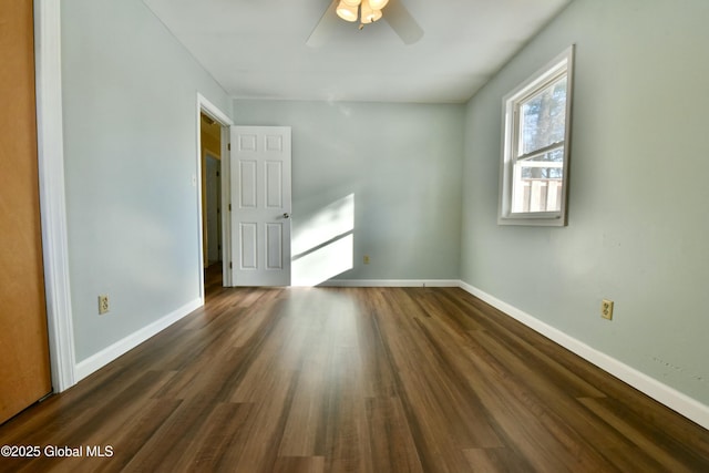 unfurnished room featuring ceiling fan and dark wood-type flooring