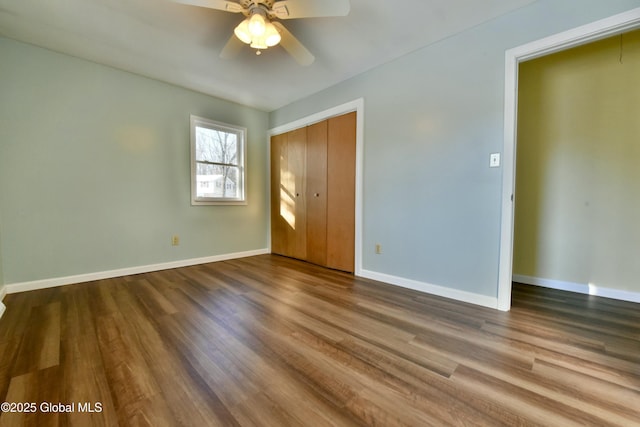 unfurnished bedroom featuring ceiling fan, a closet, and hardwood / wood-style flooring