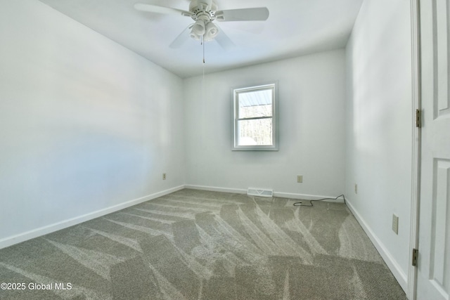 spare room with ceiling fan and carpet