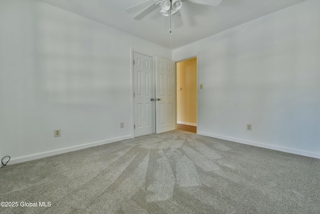 spare room featuring ceiling fan and light colored carpet