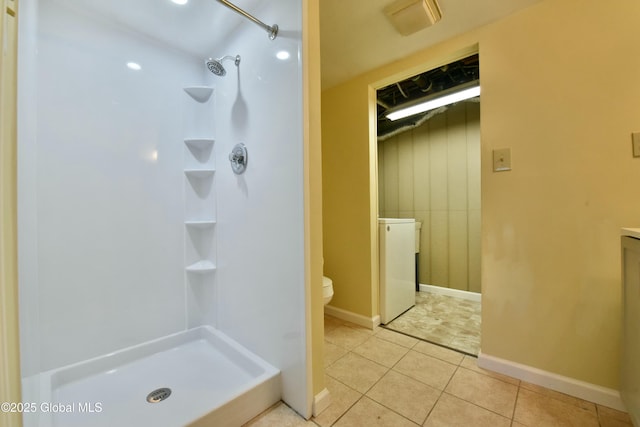 bathroom with toilet, tile patterned floors, and walk in shower