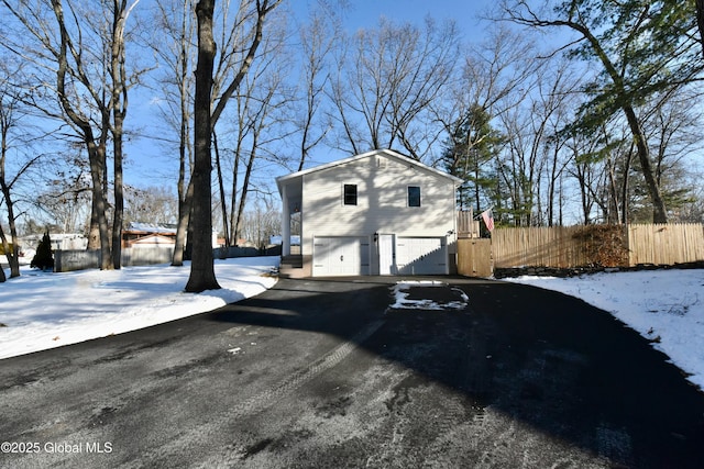 snow covered property featuring a garage