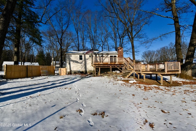 snow covered property featuring a deck