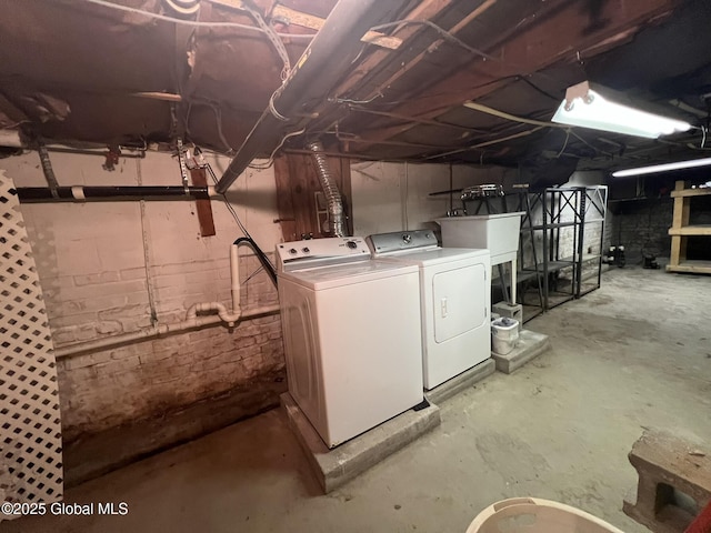 basement with sink and washing machine and clothes dryer