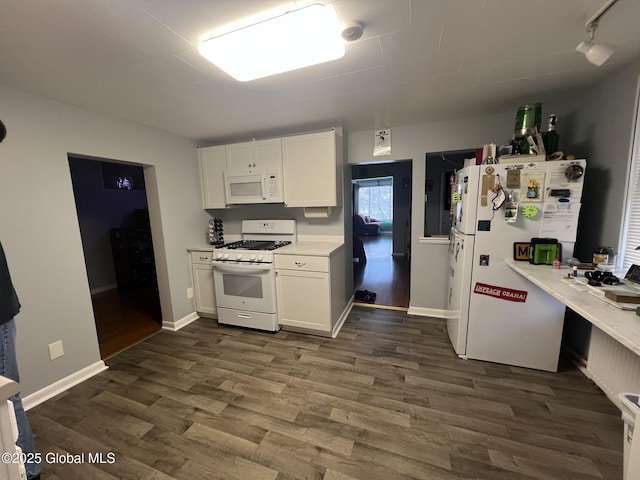 kitchen featuring white appliances, dark wood-type flooring, and white cabinets