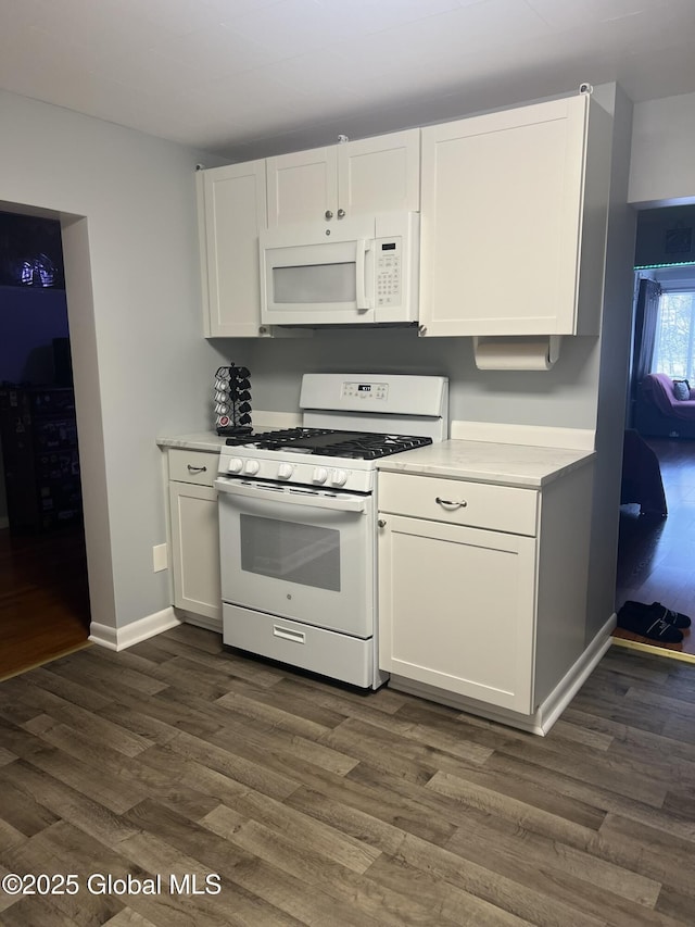 kitchen featuring white cabinetry, white appliances, and dark hardwood / wood-style flooring