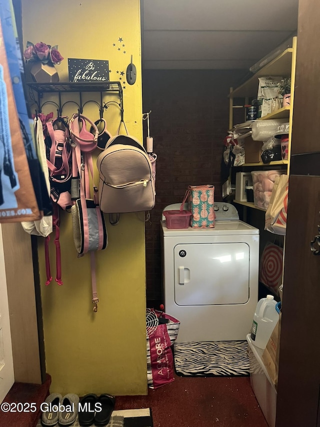 clothes washing area with washer / clothes dryer