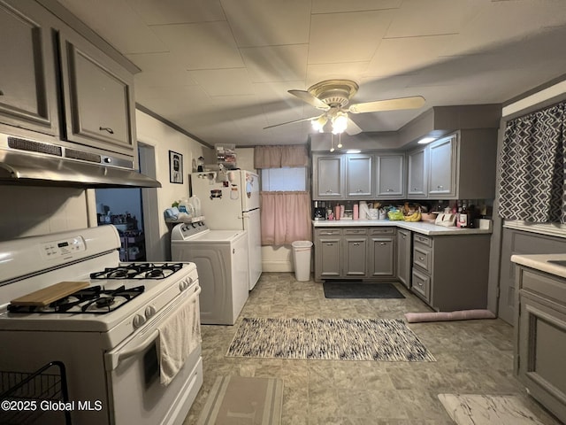 kitchen with washer and dryer, ceiling fan, gray cabinets, and white range with gas stovetop