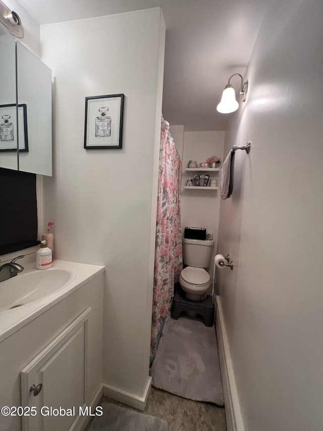 bathroom featuring vanity and toilet