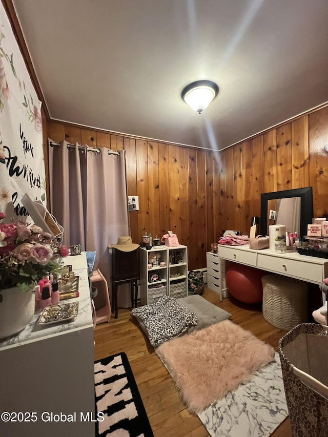 interior space featuring light hardwood / wood-style flooring and wood walls