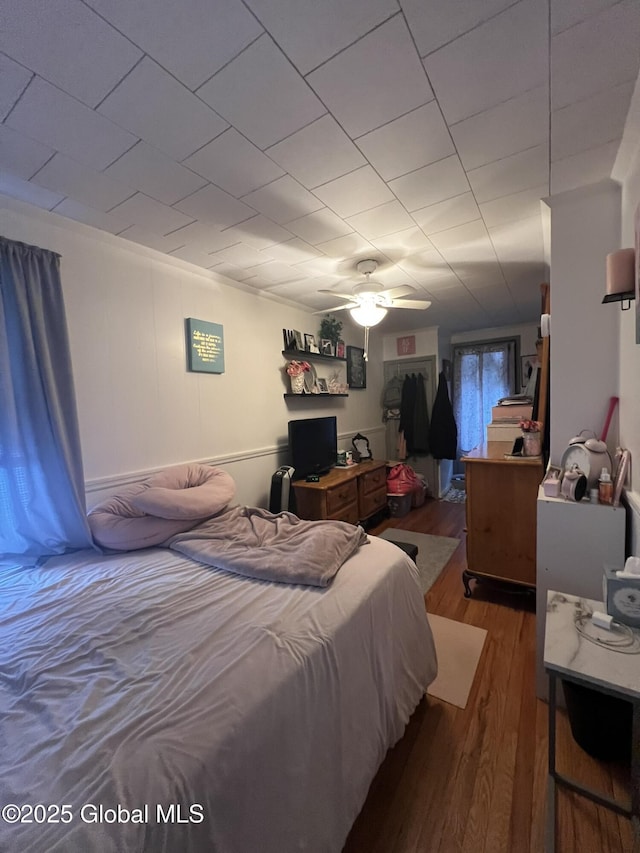 bedroom with hardwood / wood-style floors and ceiling fan