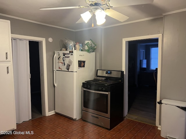 kitchen featuring ceiling fan, stainless steel range with gas stovetop, ornamental molding, dark tile patterned flooring, and white fridge