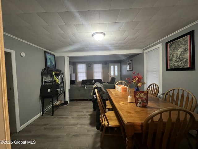 dining room with hardwood / wood-style flooring and ornamental molding