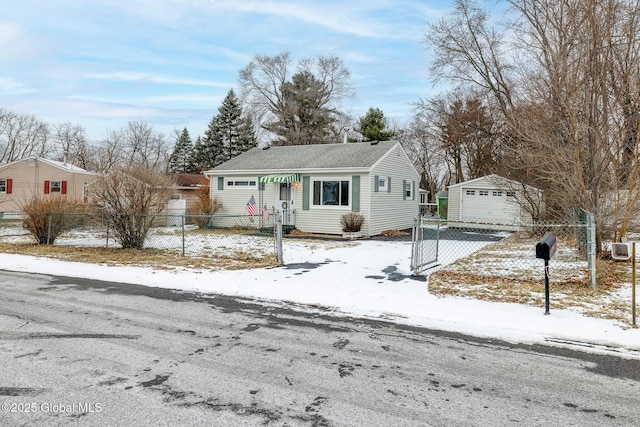 view of front of home with a garage and an outbuilding