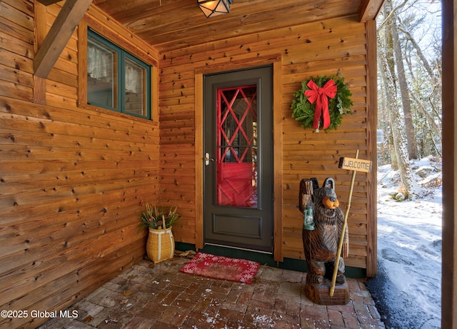 view of snow covered property entrance