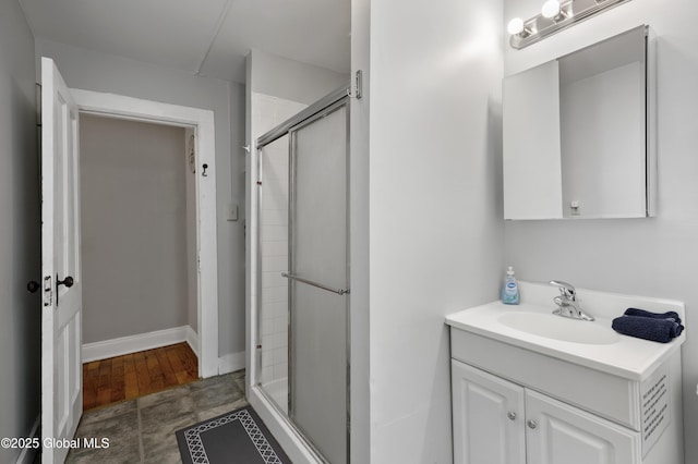 bathroom featuring an enclosed shower and vanity