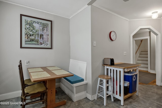 dining space featuring crown molding