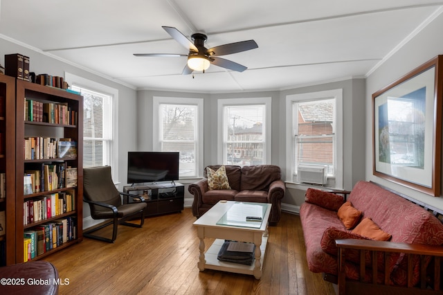 living room with ceiling fan, a wealth of natural light, crown molding, and hardwood / wood-style flooring