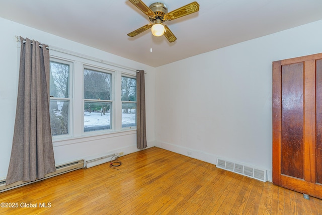 spare room featuring ceiling fan and light hardwood / wood-style flooring