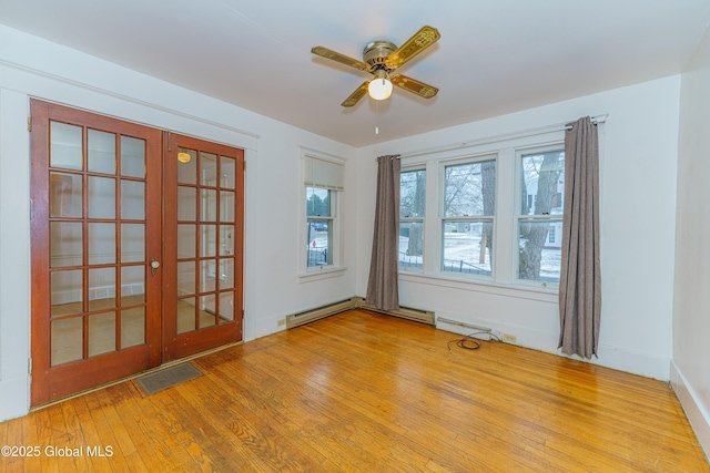 unfurnished room featuring ceiling fan, baseboard heating, french doors, and light hardwood / wood-style floors