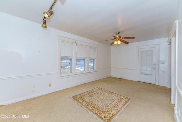 carpeted empty room featuring ceiling fan