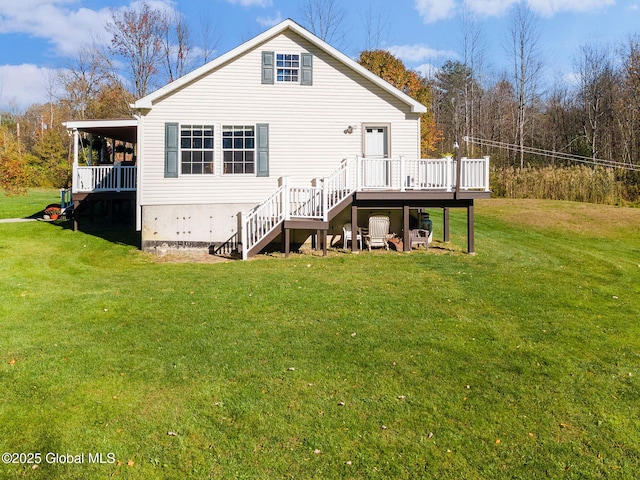 back of house featuring a yard and a wooden deck