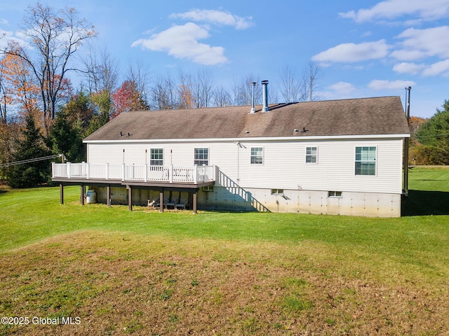 back of house featuring a lawn and a wooden deck