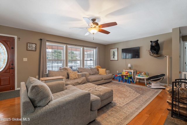 living room featuring ceiling fan and light wood-type flooring