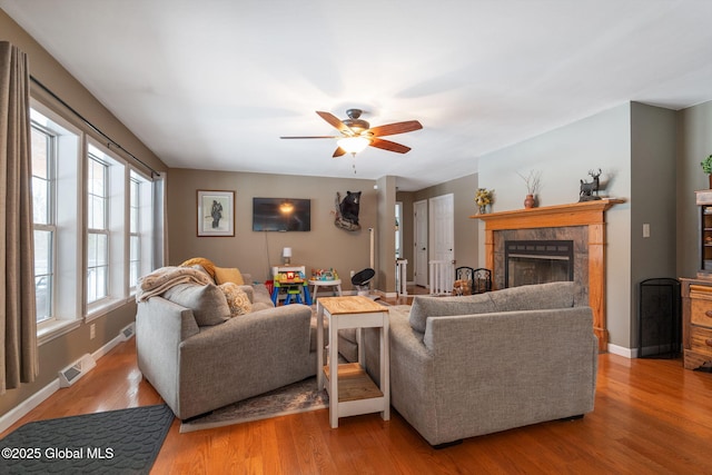 living room with ceiling fan, light hardwood / wood-style floors, and plenty of natural light