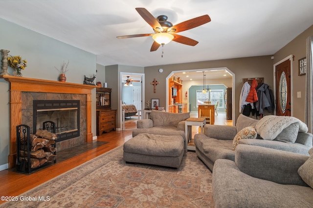 living room featuring ceiling fan and wood-type flooring