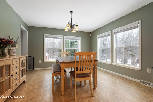 dining area featuring a notable chandelier