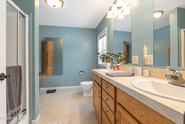 bathroom featuring toilet, vanity, and walk in shower