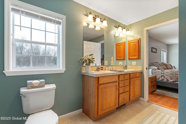 bathroom with toilet, tile patterned floors, and vanity