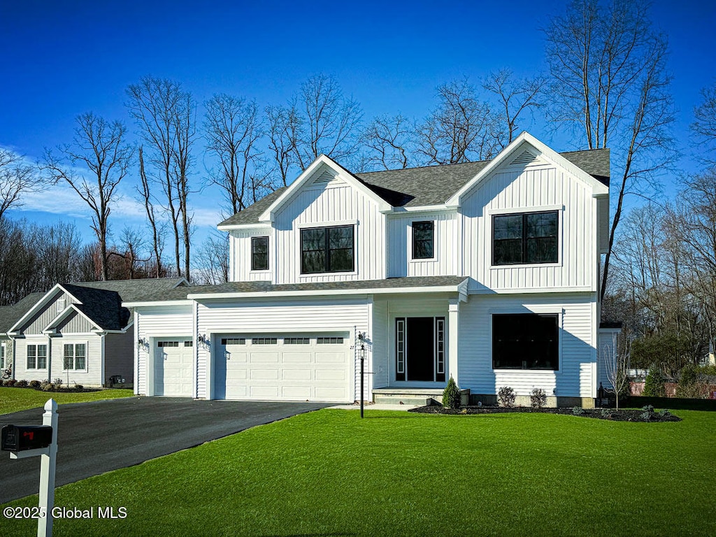 view of front of house featuring a garage and a front lawn