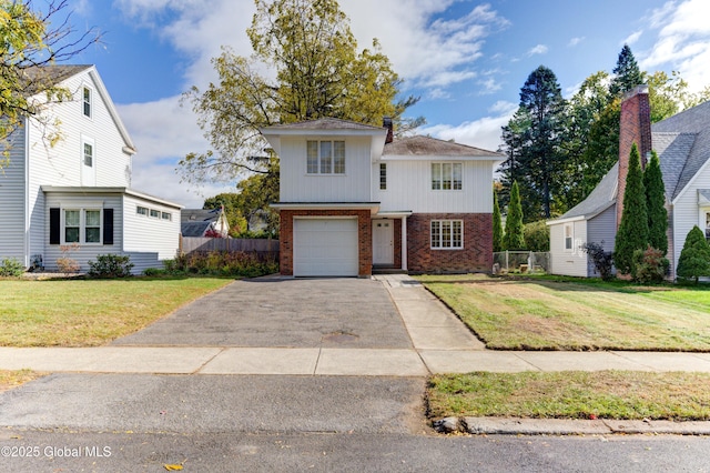 view of property with a front yard and a garage