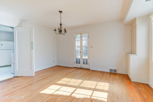 interior space featuring a chandelier and light wood-type flooring