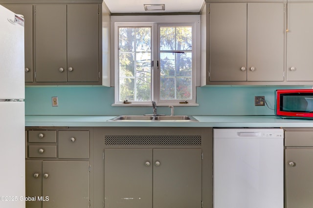 kitchen with white appliances, gray cabinets, and sink