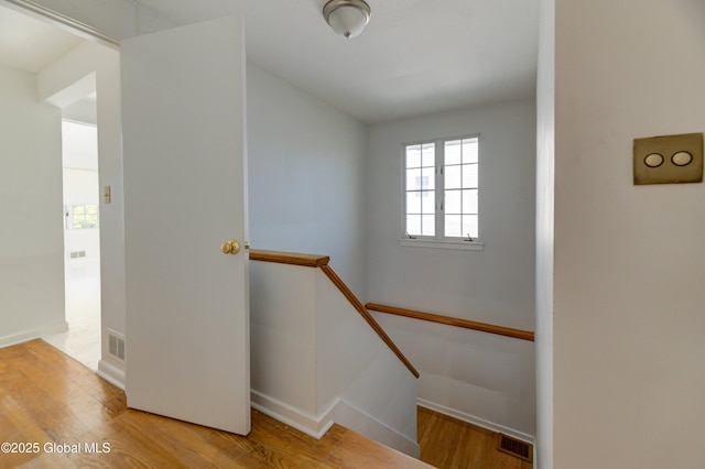 stairs featuring wood-type flooring