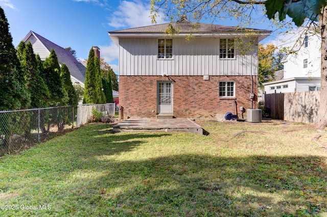 back of property with a yard, a patio, and central air condition unit