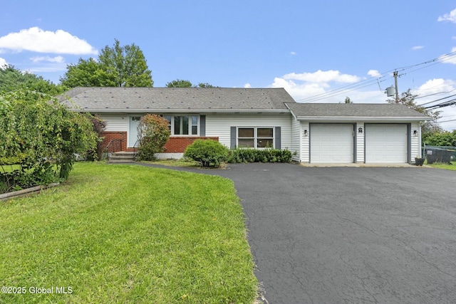 ranch-style home with a garage and a front lawn