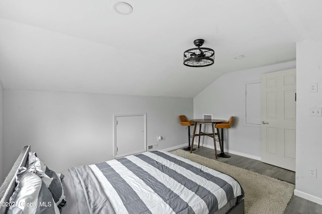 bedroom featuring lofted ceiling and dark hardwood / wood-style flooring