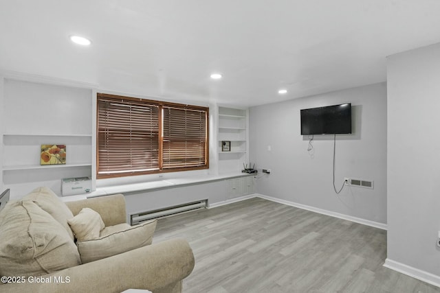 living room with light hardwood / wood-style flooring and a baseboard radiator