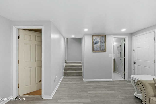 corridor with light hardwood / wood-style floors