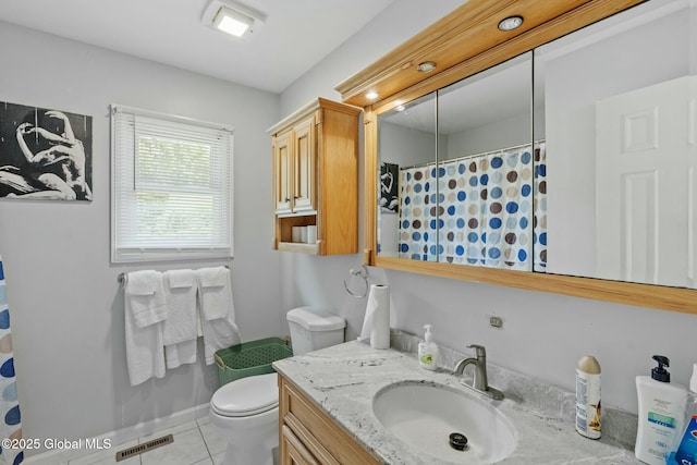 bathroom featuring tile patterned floors, vanity, and toilet