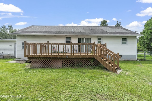 back of property featuring a deck and a lawn