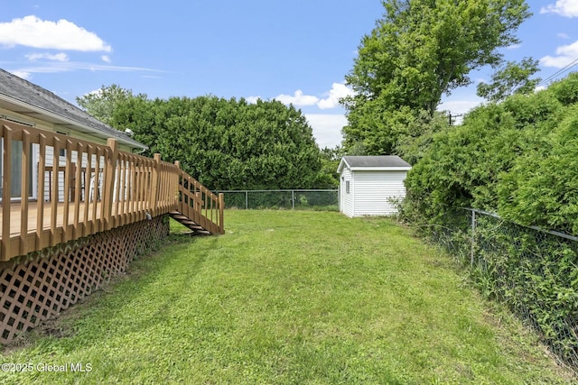 view of yard featuring a storage shed and a deck